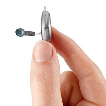 Person holding RIC hearing aid