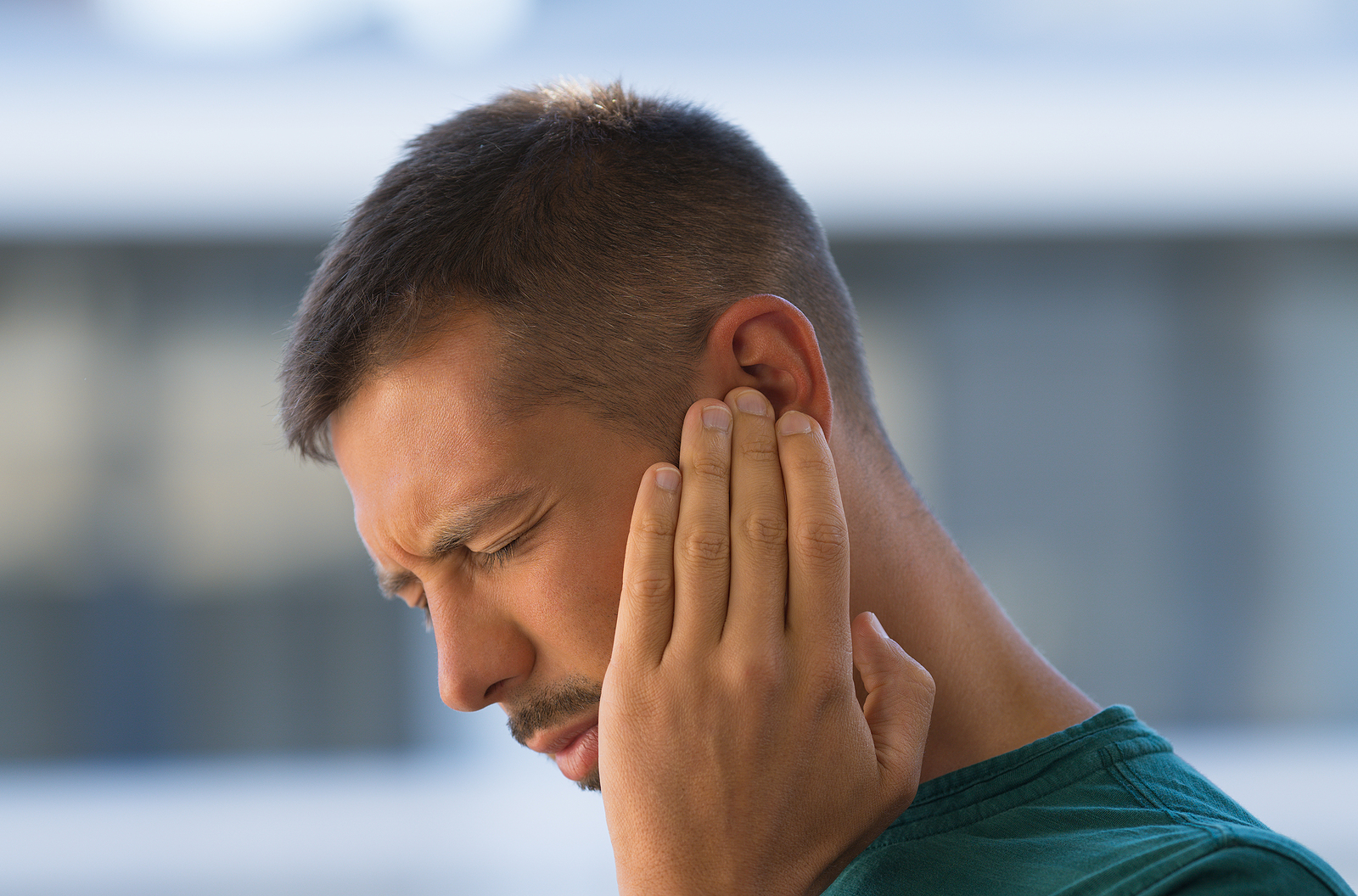 Young Man With Earache, Otitis Or Tinnitus. Ear Inflammation