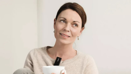 woman holding cup of coffee